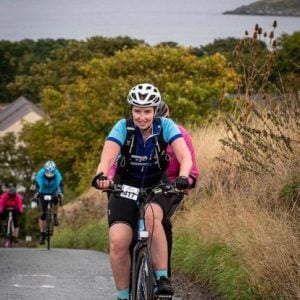 Zara Jones piloting a Vie Velo tandem in Poppy Scotland sportive.